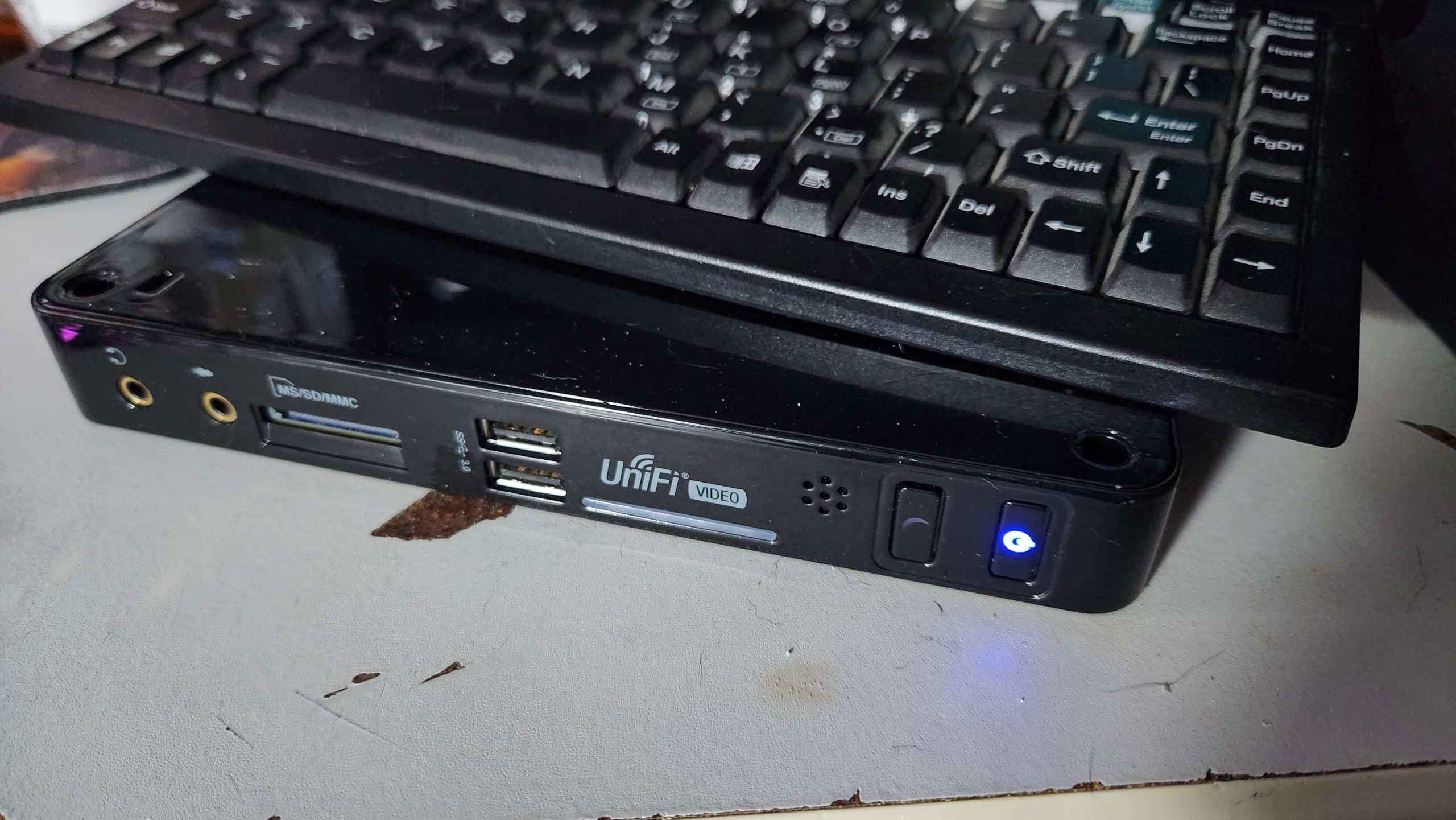 Unifi Video NVR sitting on desk with blue Power LED